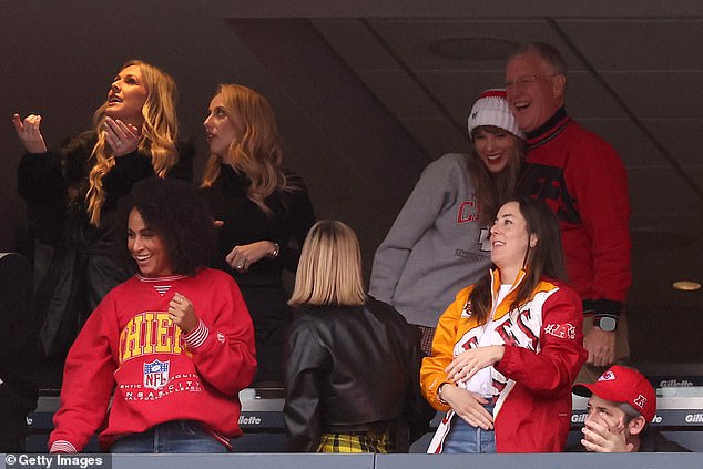 Swift hared a hug with her dad, Scott, in a suite at Gillette Stadium during Sunday's game