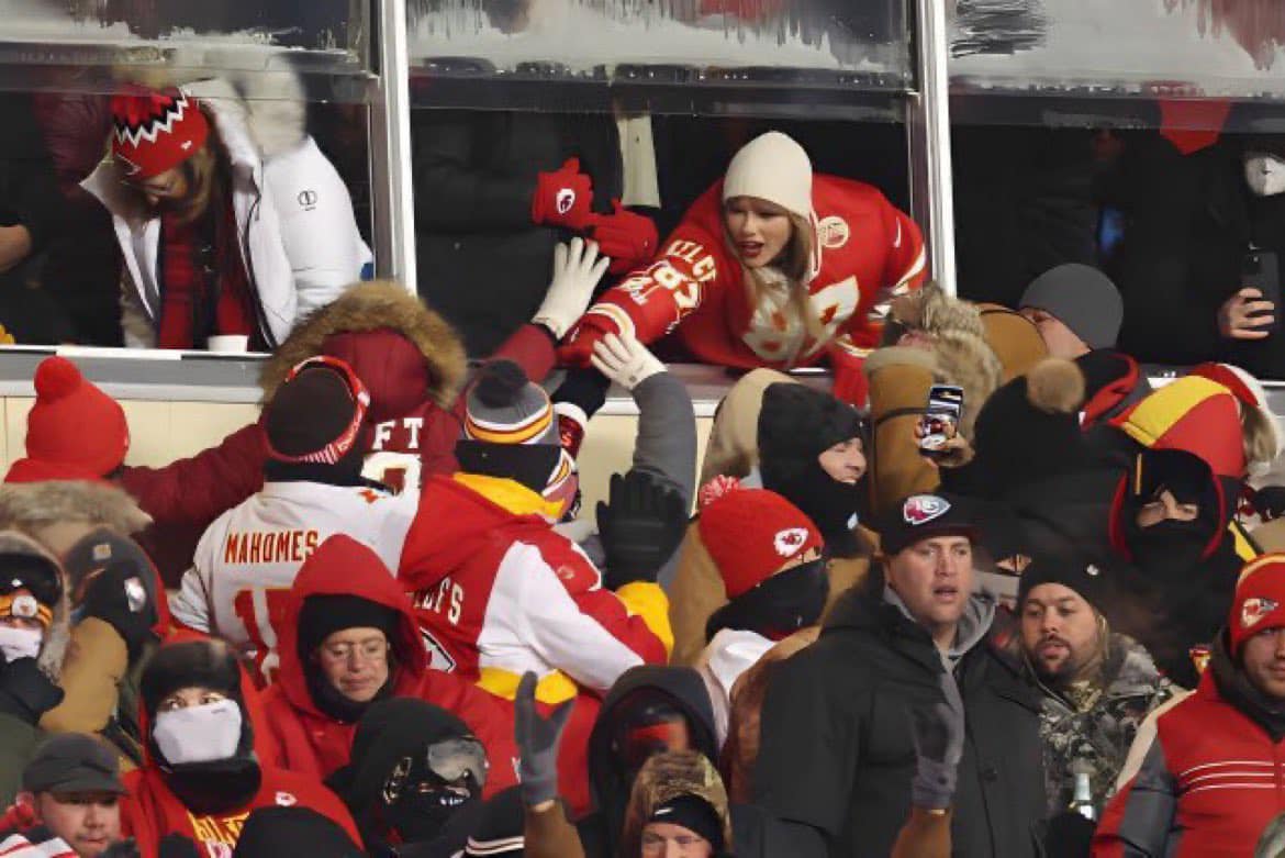 May be an image of 4 people, people playing football, crowd and text