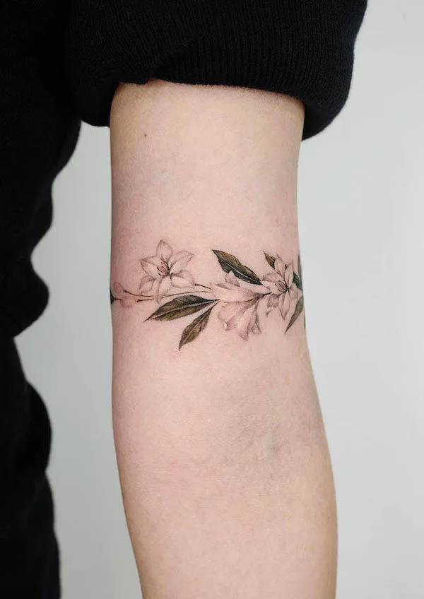 Flowers and leaves armband tattoo by @donghwa_tattoo