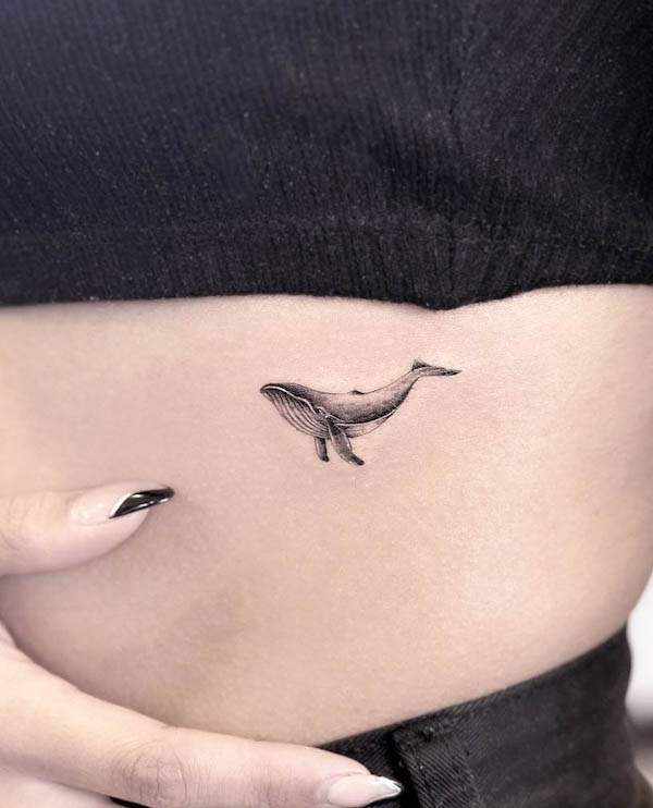 Tiny blue whale rib tattoo by @tayeh.studio