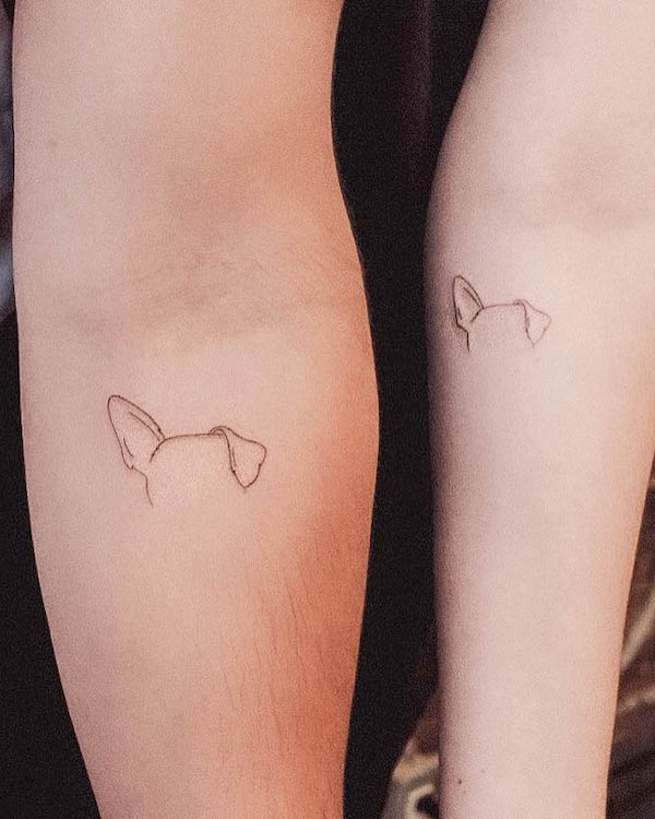 Matching dog ear tattoos by @tavi_tattoo