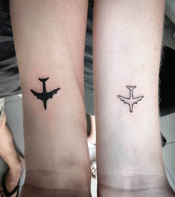 Matching plane tattoos by @twisted_ink_ballito