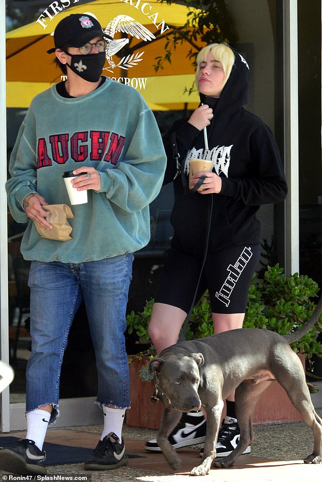 Casual: Still sporting her new platinum locks, Eilish kept it casual in black Jordan bike shorts and a black Snoop Dogg hoodie that was tugged up over her hair.