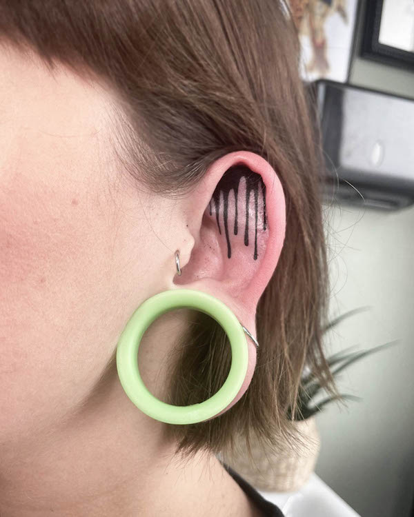 Dripping ink ear tattoo by @rhi.draws