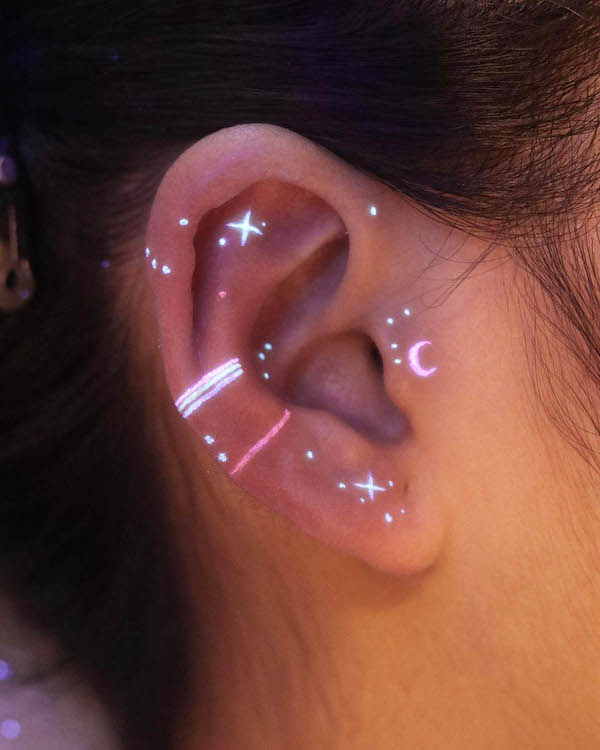 Invisible UV ear tattoo by @nhi.ink