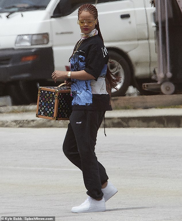 Top off: The look was topped off with a colorful scarf tucked in to her shirt