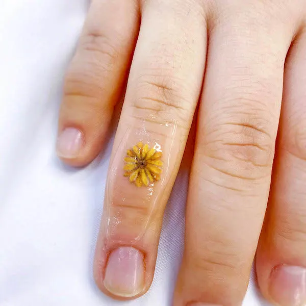 Small sunflower hand tattoo by @sinbar_tattoo