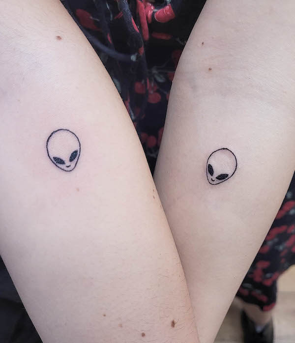 Tiny alien tattoos for couple by @richierichtattoos