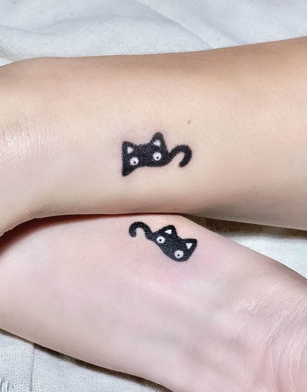 Matching black cat tattoos for couple by @ladyinblueink