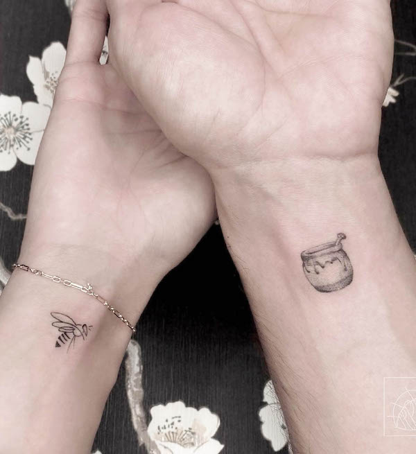 Bee and honey pot matching wrist tattoos by @neko.tattooartstudio