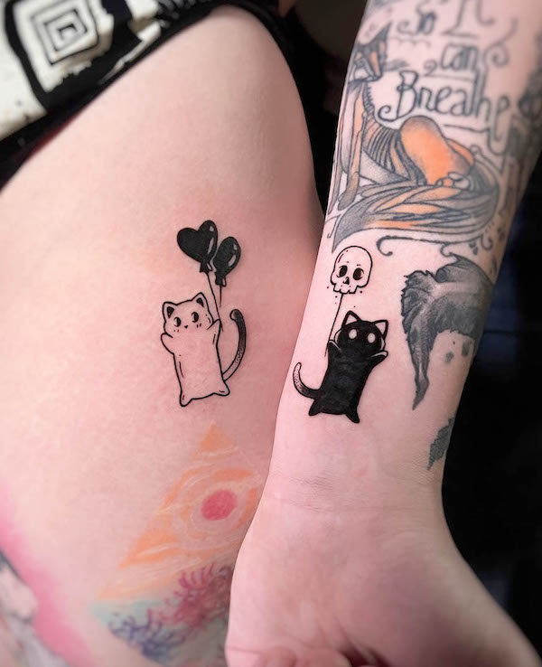 Black and white cat tattoos for couple by @ritualtattoo.studio