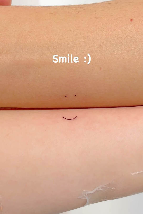 Small smile tattoos for couple by @masa_tattooer