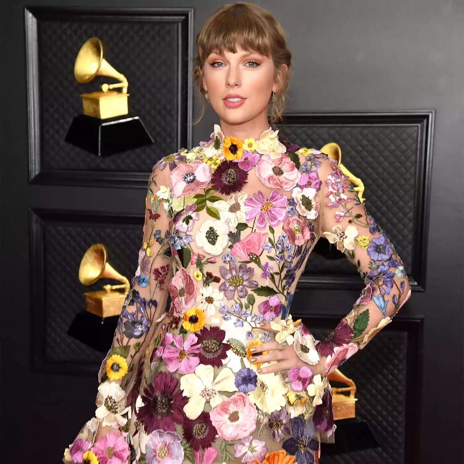 Taylor Swift wearing a floral mini dress at the 2021 Grammys.