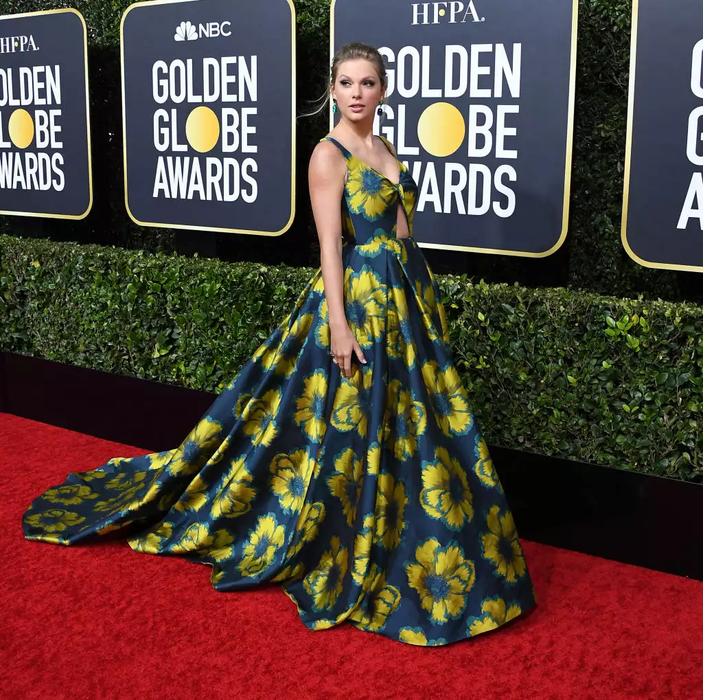 Taylow Swife wearing a navy gown with yellow flowers at the 77th Annual Golden Globe Awards