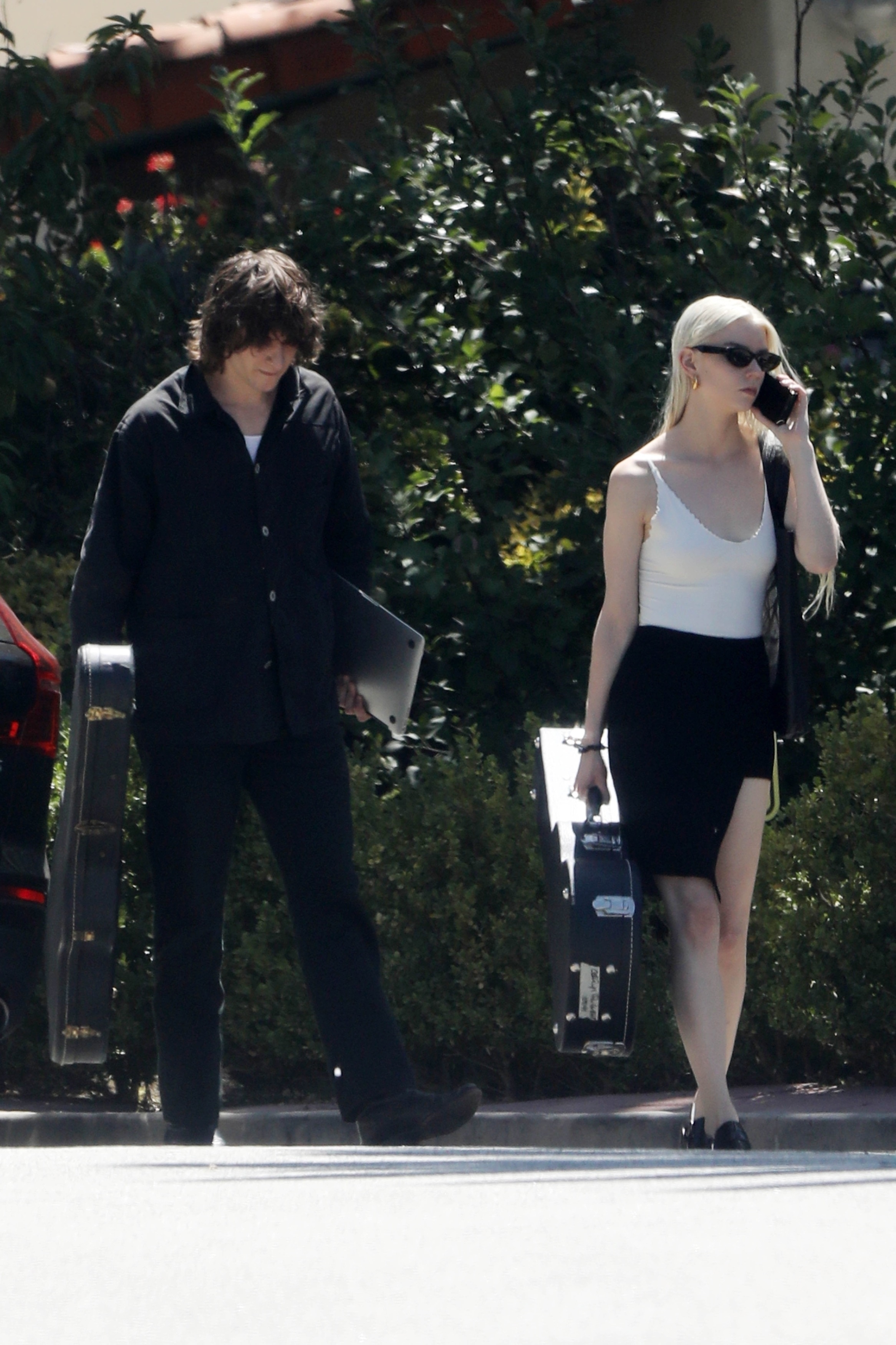 Anya Taylor-Joy and husband Malcolm McRae carrying guitars.