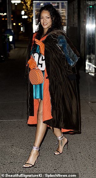 Making a style statement: Rihanna rocked a turquoise sports jersey with orange accessories