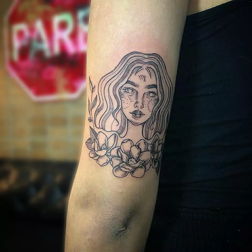 Image of a Virgo maiden tattoo on the back of someone's arm