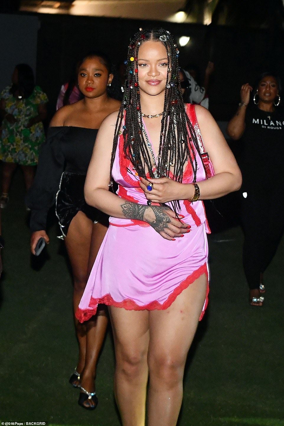 Stylish: While rocking a pink minidress and red high heels, the Diamonds hitmaker was seen wrapping her legs around her beau, who seemed to carry her with ease as they listened to Popcaarn, Bounty Killer and Michel Montano perform on stage