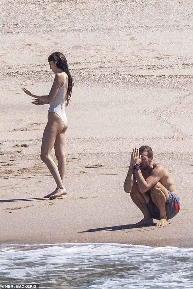 As they prepared to leave the beach, Johnson threw up her long brown hair in a tight bun