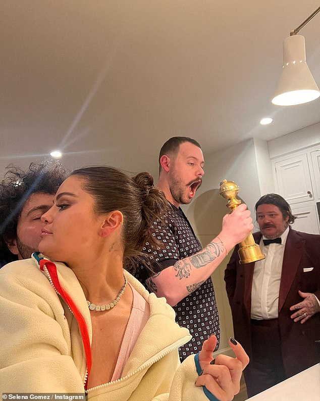 Blanco was posed behind Gomez as they relaxed in the kitchen area of a home alongside friends including The Bear actor Matty Matheson