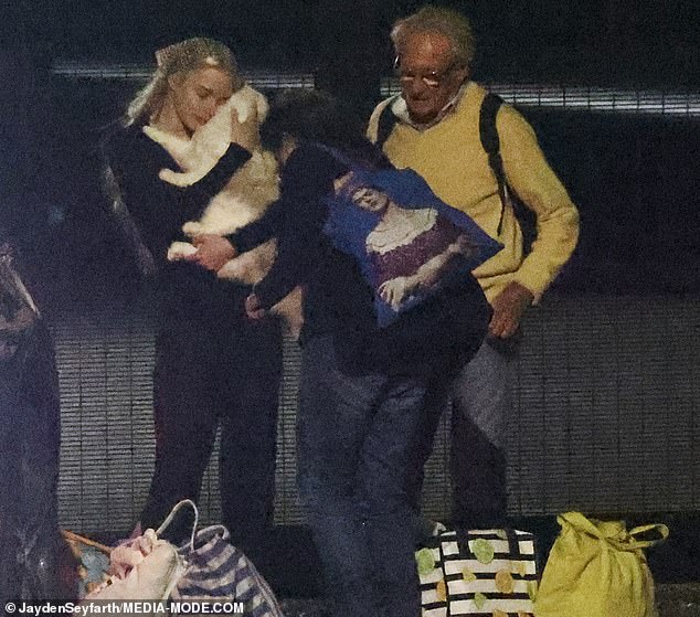 Anya shared several cuddles with Kitsune as her father Dennis and her entourage loaded some luggage into a car