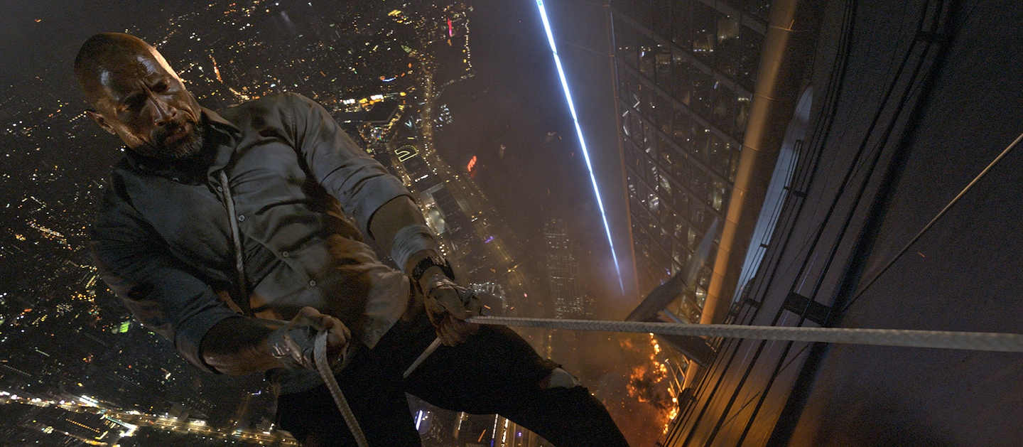 In 'Skyscraper,' The Rock jumps off a crane into a burning building. Hey,  it's summer.