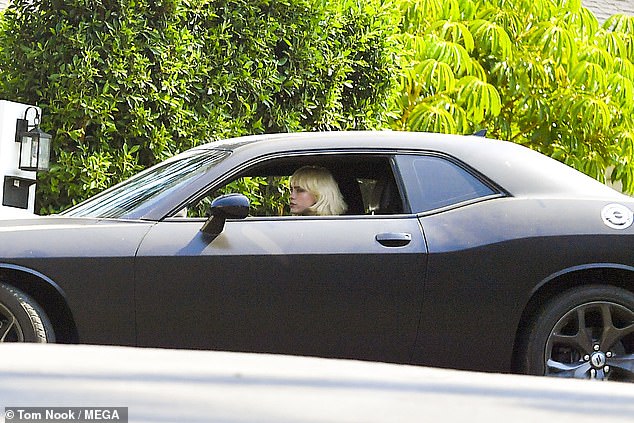 Vroom: Ready to go home after an afternoon of music, they hopped into Billie's black sports car and headed off