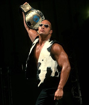 The Rock on stage wearing his signature cow print sleeveless top in 1999
