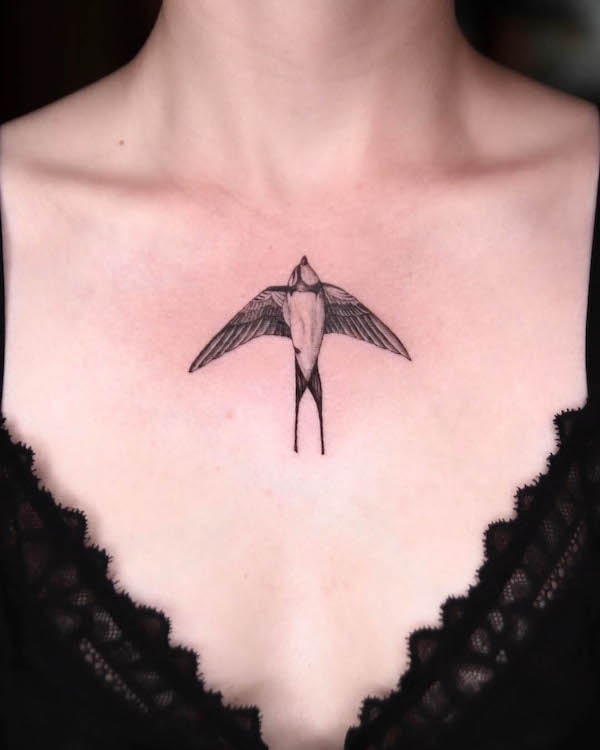 Swallow chest tattoo by @ando.tattooer