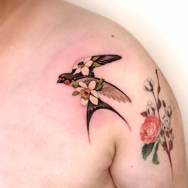 Realistic floral swallow tattoo by @aaron_tattoo2072