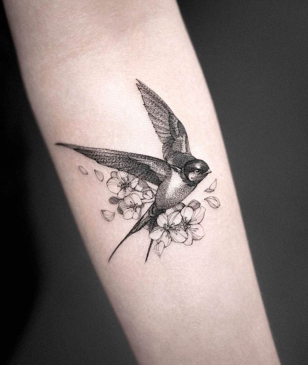 Intricate swallow with flowers tattoo by @sonya_fakas