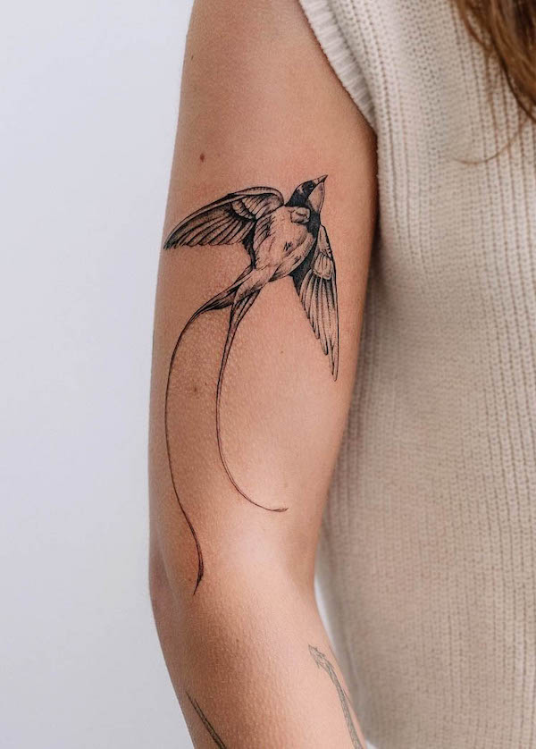 Elegant swallow arm tattoo for women by @tattoobymeg