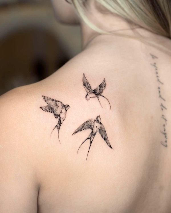 Tiny swallows on the back by @picciott_ink