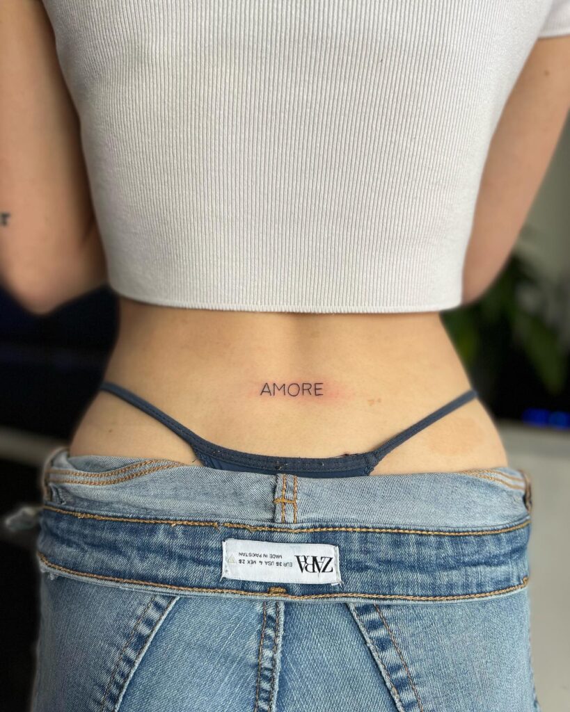 'AMORE' Fineline Text Lettering Tattoo on the Lower Back: Timeless Affection
