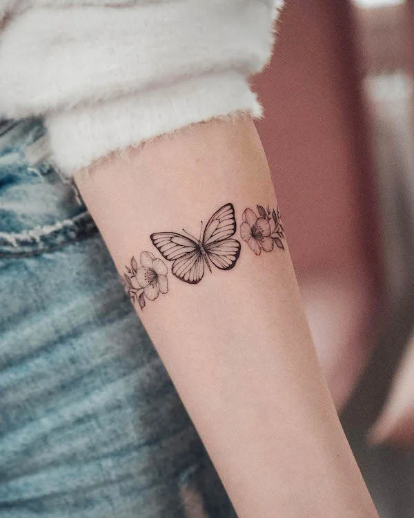 Butterfly and flowers bracelet tattoo by @bunami.ink_