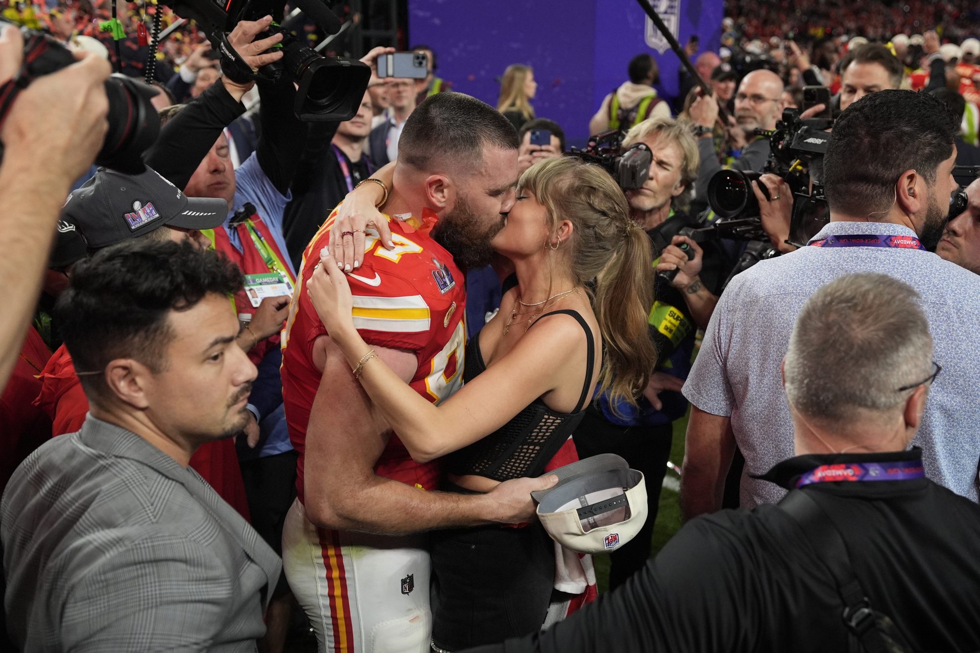 Travis Kelce and Taylor Swift kiss after the Chiefs win the Super Bowl.