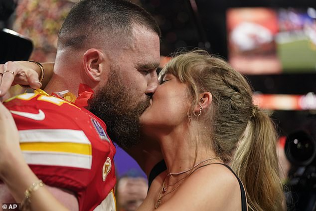 The power couple share a kiss on the field following the Chiefs' Super Bowl victory