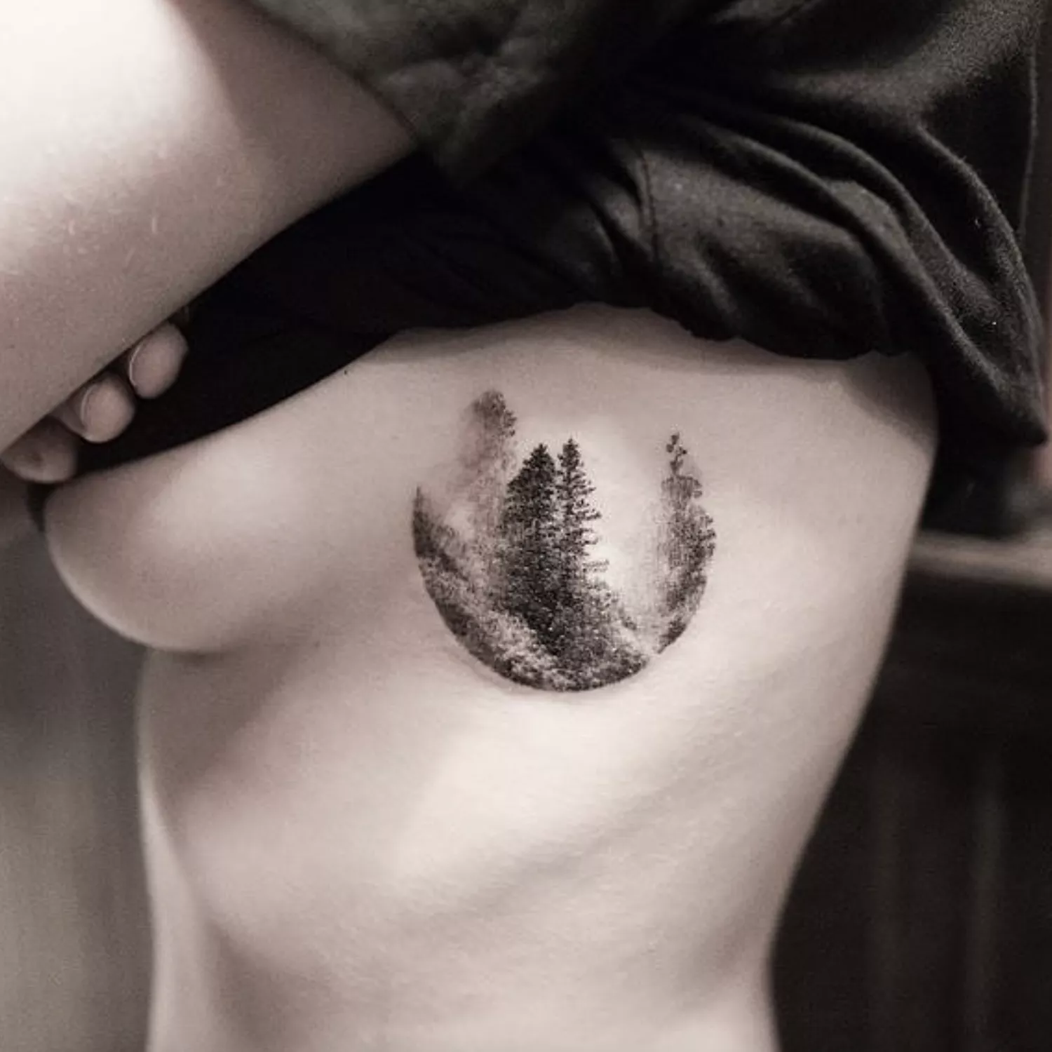 Ribcage tattoo of circular forest vignette