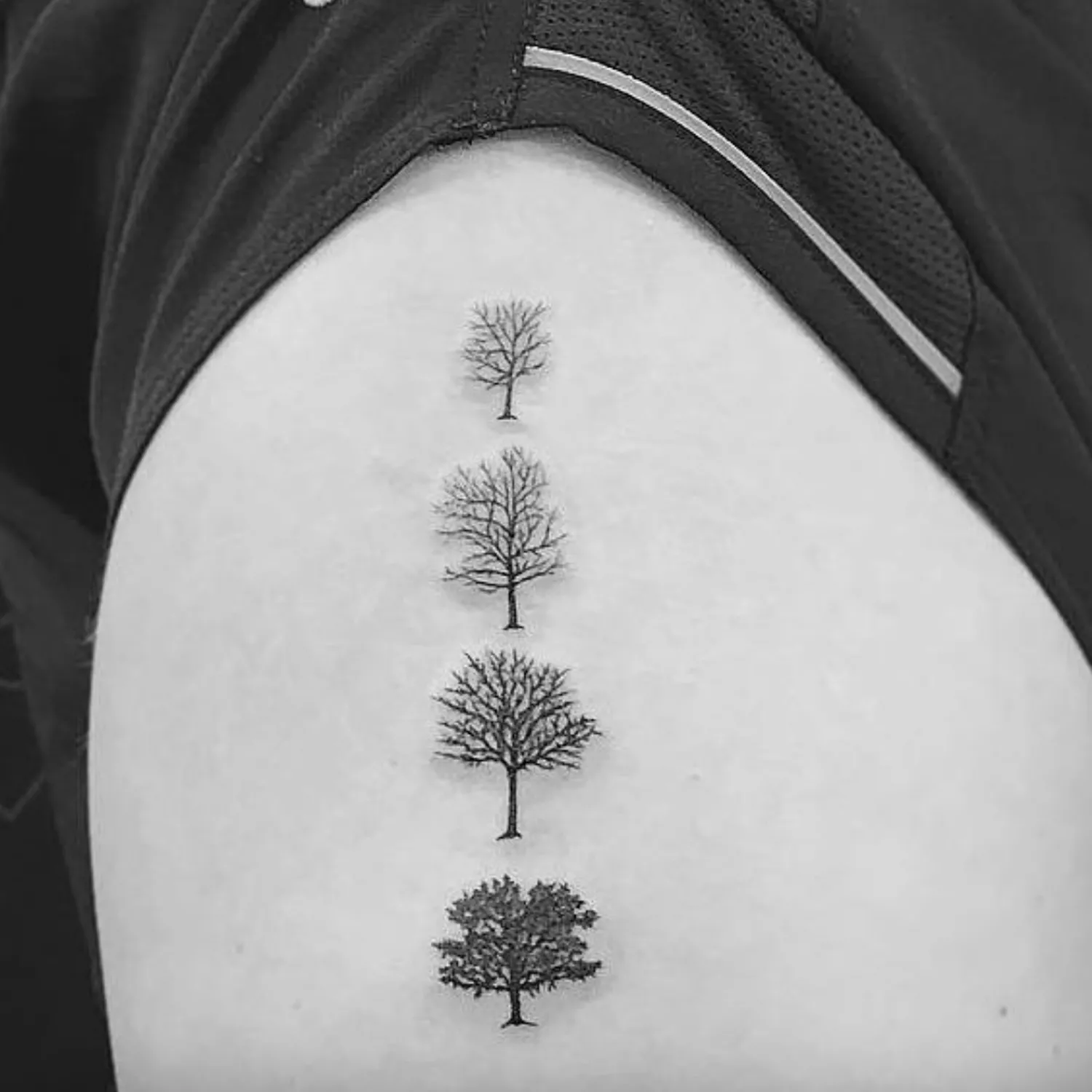 Tattoo of four trees in various seasons