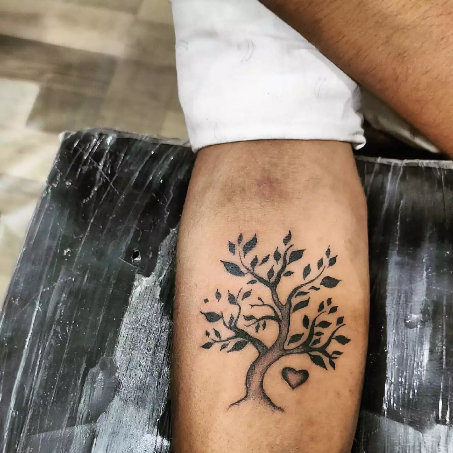 Close up of a tree and heart tattoo