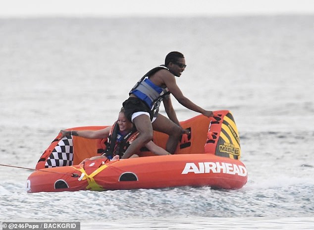 The star appeared to be enjoying her beach break as she screamed with excitement while the boat sped along the waves