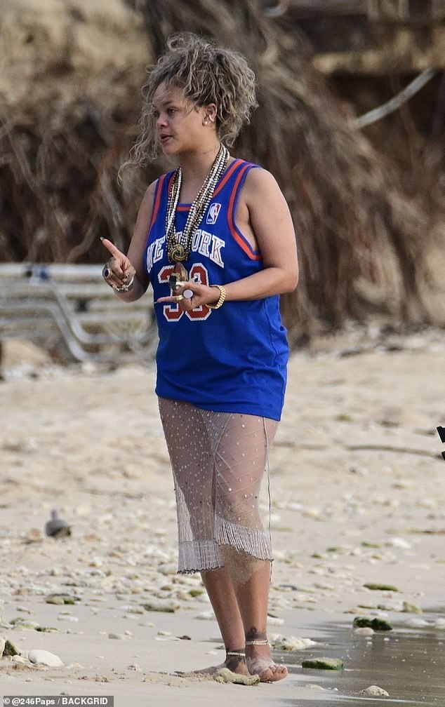 She showed off her curves in the revealing sheer skirt and oversized sports jersey