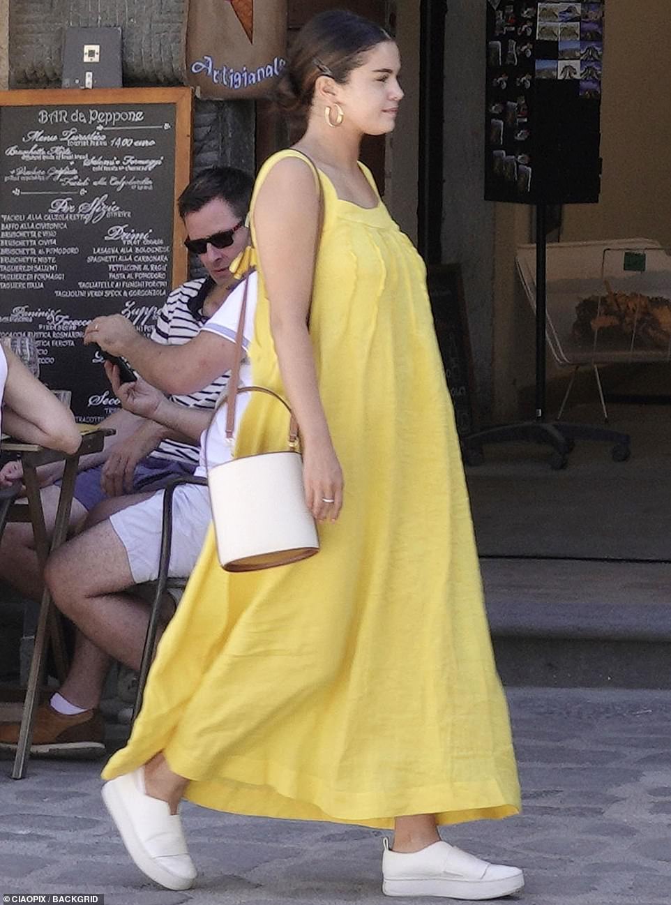 Gorgeous: Selena was the definition of summer, stunning in a yellow linen maxi dress for the outing