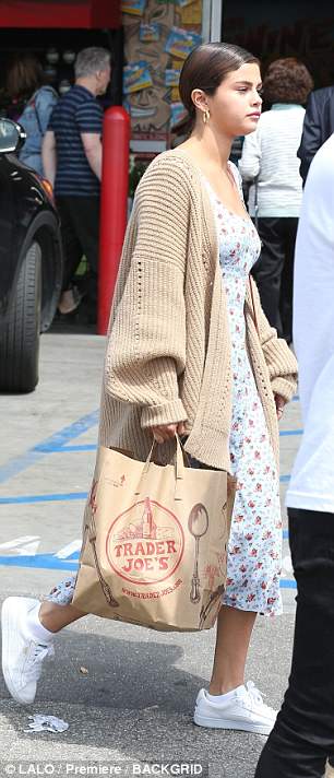 Fun: She added a sporty element to her spring ensemble with a pair of crisp white trainers laced up her feet