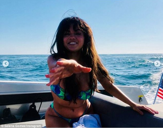 Pretty: The Monte Carlo star donned a low-cut bikini top that featured a bow detail in the center; the green and blue patterned number showed off her chest