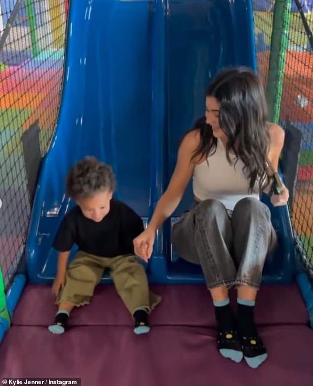 Kylie held hands with her little one while enjoying their fun adventure