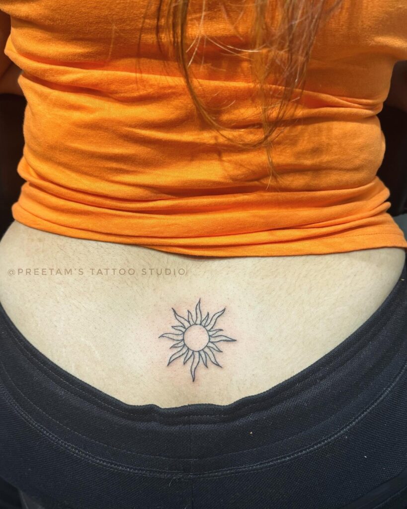 Sun Tattoo on the Lower Back: Radiant Solar Charm
