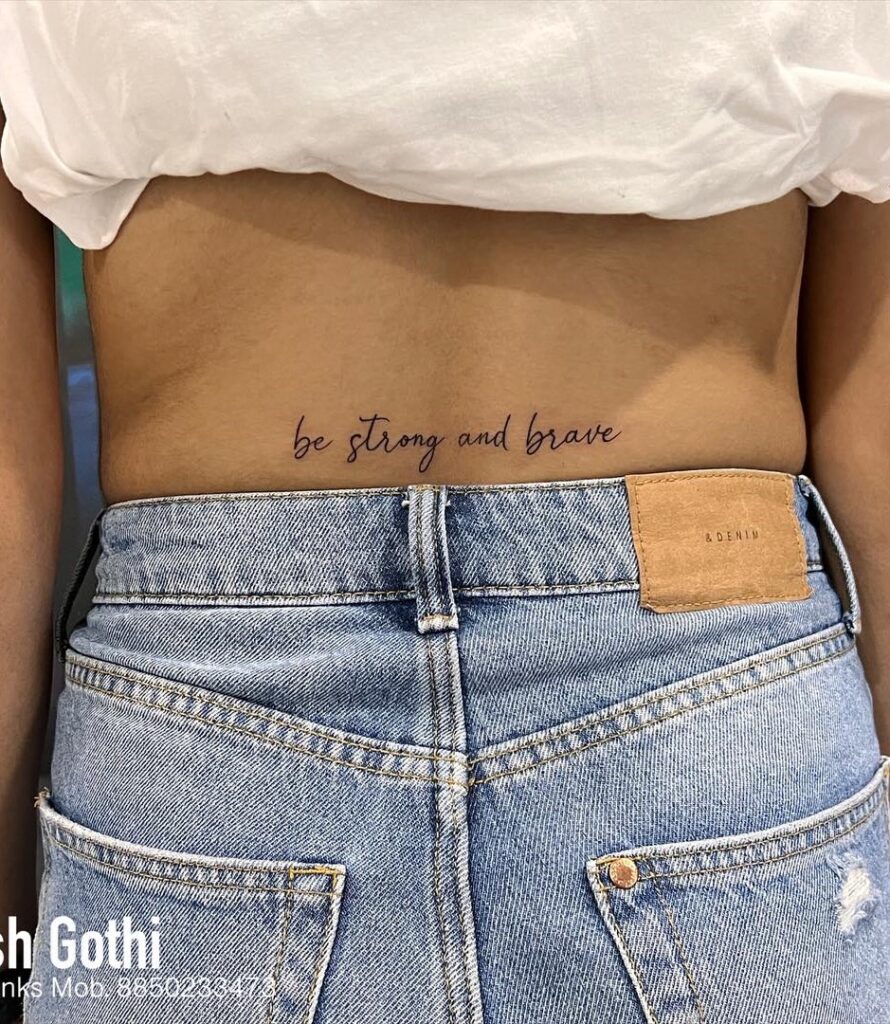 Lower Back Script Lettering Tattoo 'Be Strong and Brave': Empowering Wisdom
