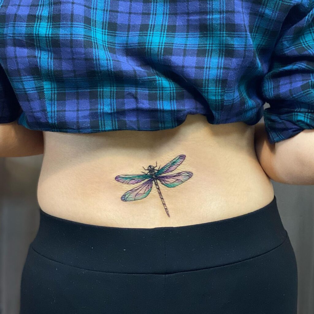 Colorful Dragonfly Tattoo on the Lower Back: Vibrant Whimsy
