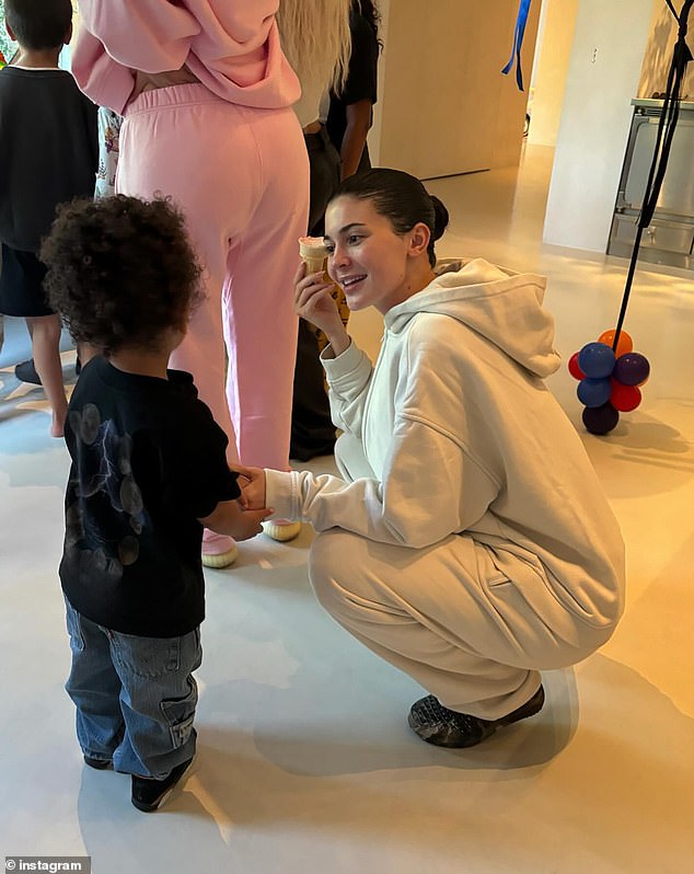 The attentive mother crouched down to interact with her little boy